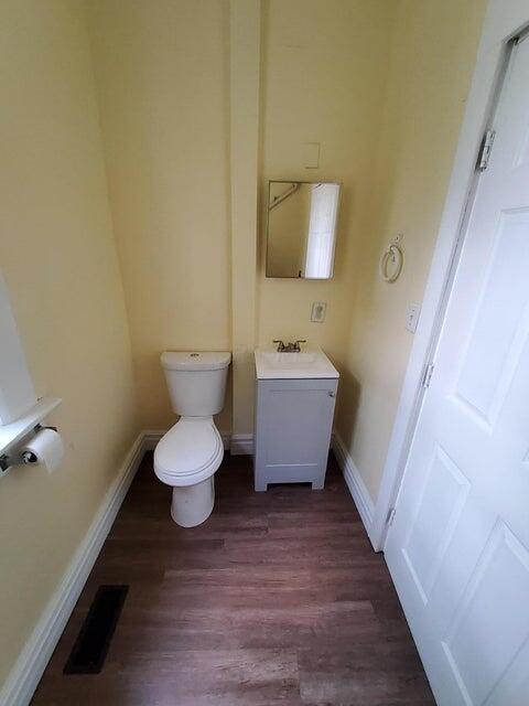 bathroom featuring hardwood / wood-style floors, vanity, and toilet