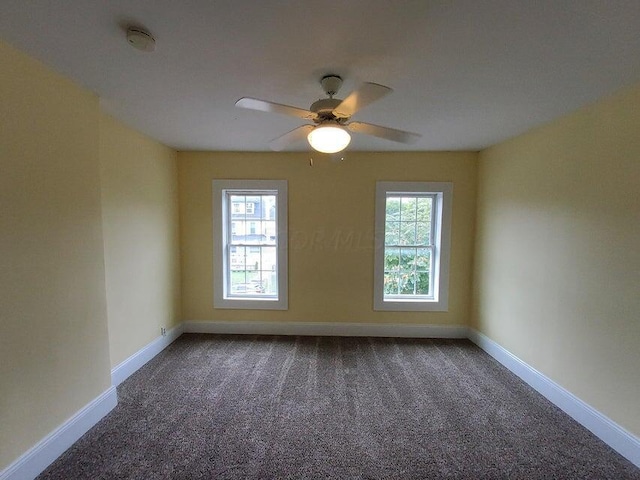 empty room with ceiling fan, carpet, and a healthy amount of sunlight