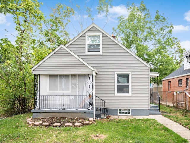 rear view of property featuring a yard