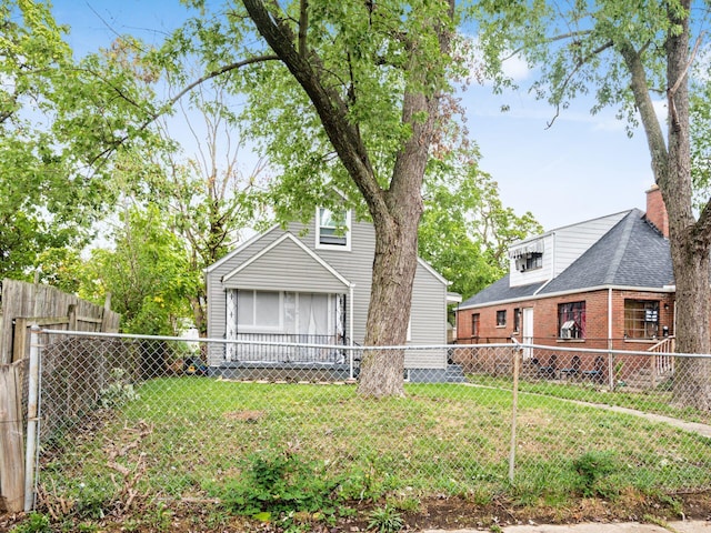 back of property featuring a lawn