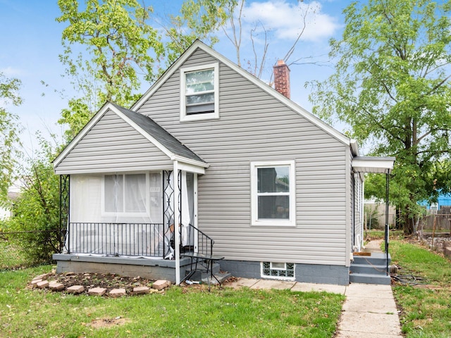 bungalow-style home featuring a front yard