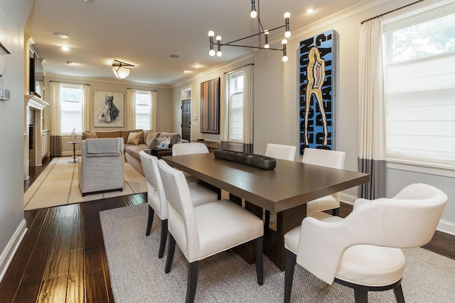 dining room featuring a chandelier, hardwood / wood-style flooring, and crown molding