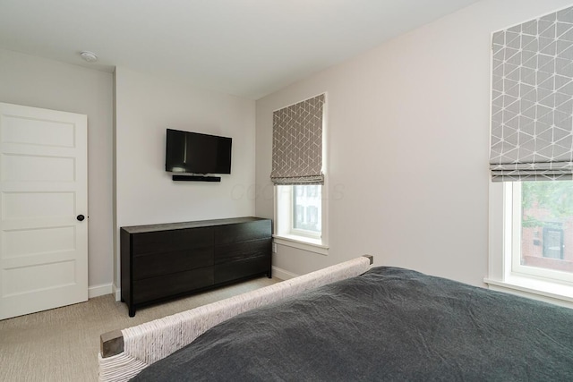 unfurnished bedroom with multiple windows and light carpet