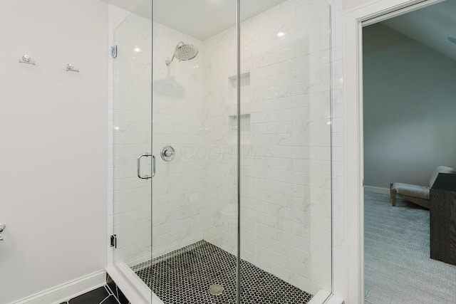 bathroom featuring a shower with door