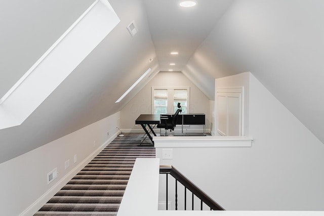 bonus room with carpet flooring and vaulted ceiling