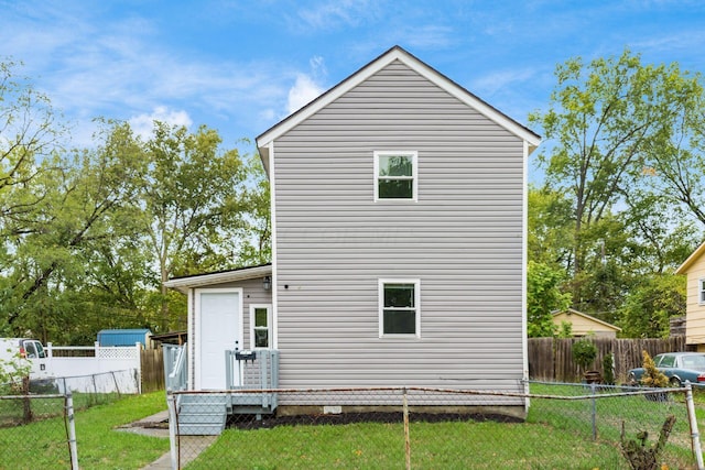 rear view of house featuring a yard