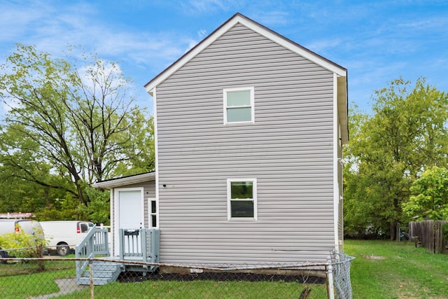 rear view of house with a yard