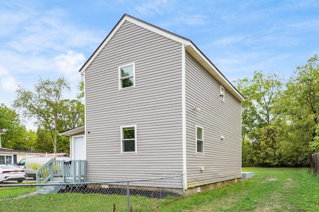 view of side of property with a yard