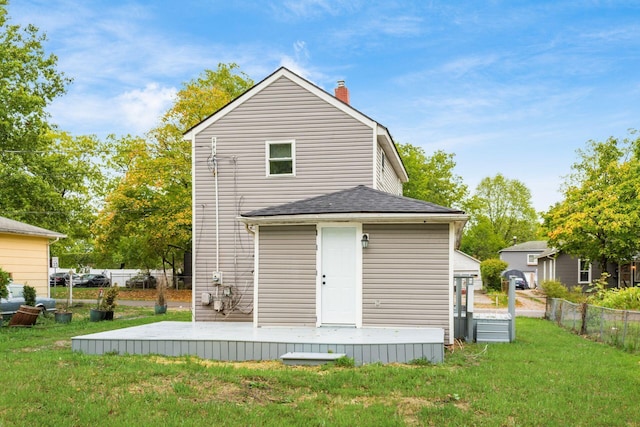 rear view of property with a lawn