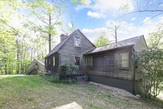 view of side of property with a lawn