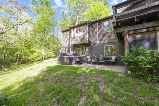 back of house featuring a patio area and a yard