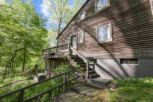 view of property exterior featuring a wooden deck