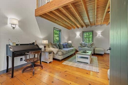 sitting room with beam ceiling, hardwood / wood-style flooring, and wood ceiling