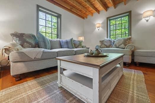 living room with dark hardwood / wood-style flooring, lofted ceiling with beams, and wood ceiling