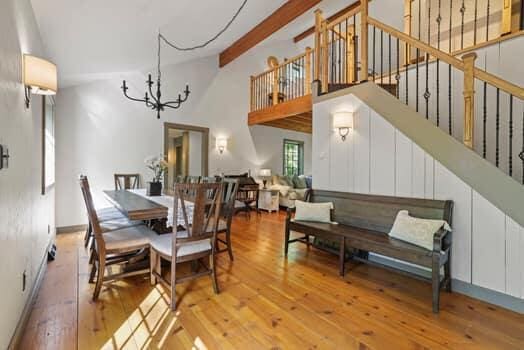 dining room with light hardwood / wood-style floors, lofted ceiling, and a chandelier