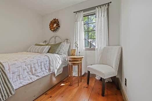 bedroom with hardwood / wood-style floors