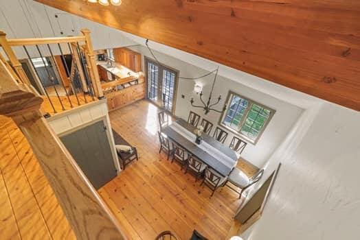 interior space featuring a chandelier, french doors, and vaulted ceiling