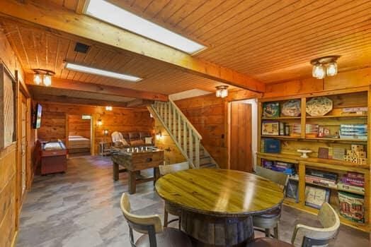 dining room featuring beam ceiling, wood walls, and wood ceiling