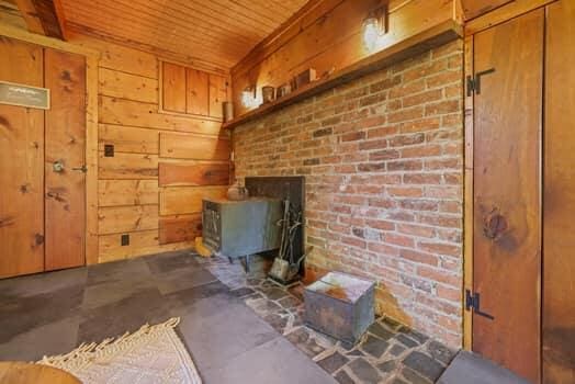 interior space featuring wood ceiling and wood walls