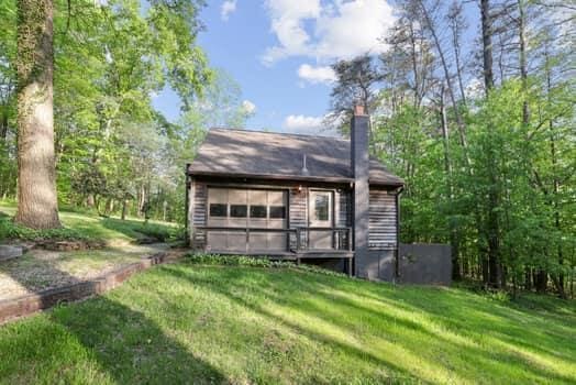 back of house with a lawn