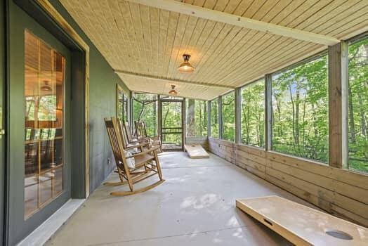 unfurnished sunroom with wooden ceiling