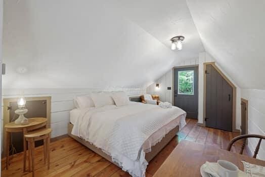 bedroom featuring hardwood / wood-style flooring and lofted ceiling