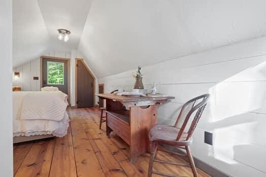 bedroom with light hardwood / wood-style floors and vaulted ceiling