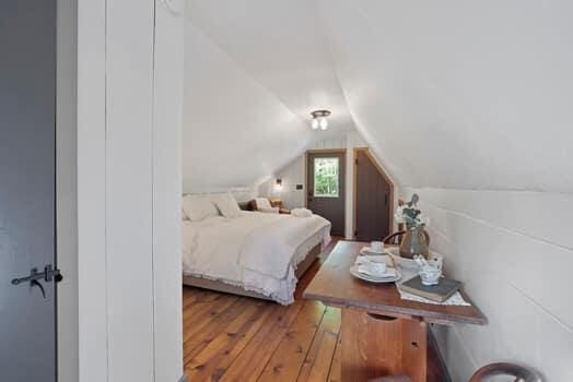 bedroom with hardwood / wood-style floors and lofted ceiling