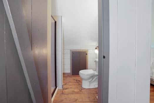 bathroom with hardwood / wood-style flooring and toilet