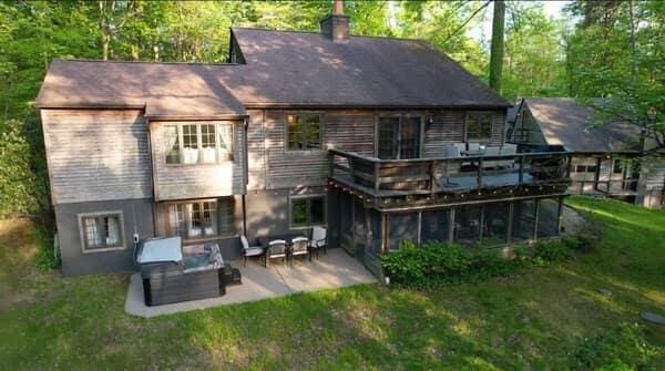 rear view of house with a lawn, a patio area, an outdoor hangout area, and a deck