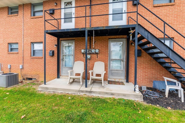 back of house featuring central AC unit and a balcony