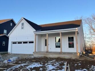 view of front of home featuring a porch and a garage