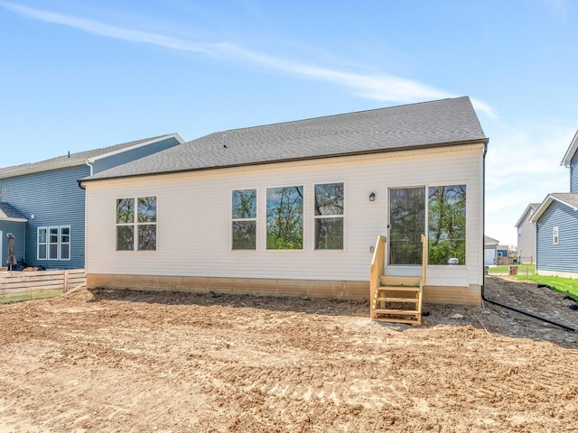 back of house featuring entry steps and fence