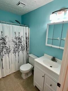 bathroom with curtained shower, tile patterned floors, a textured ceiling, toilet, and vanity