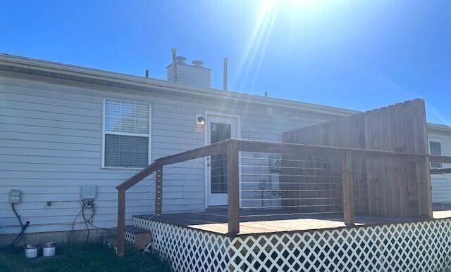 view of home's exterior featuring a wooden deck