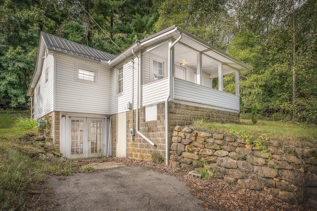 view of side of property with french doors