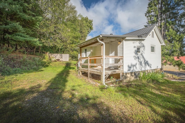 view of side of property with a porch and a lawn