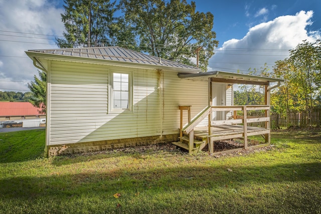 back of house with a lawn