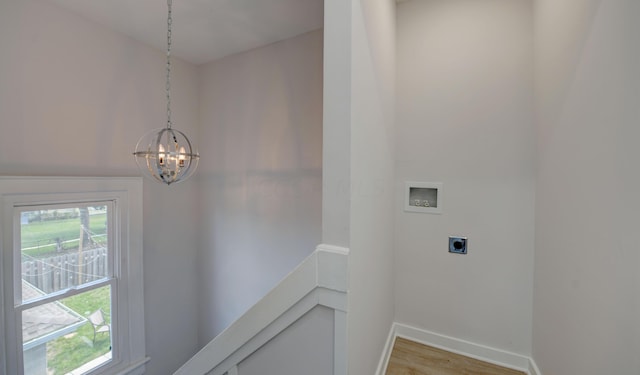 laundry room featuring washer hookup, an inviting chandelier, electric dryer hookup, and wood-type flooring