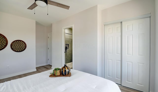 bedroom with ceiling fan, a closet, and light wood-type flooring