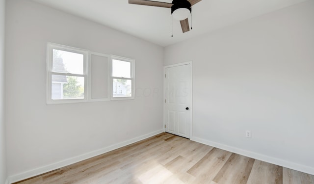 empty room with ceiling fan and light hardwood / wood-style floors