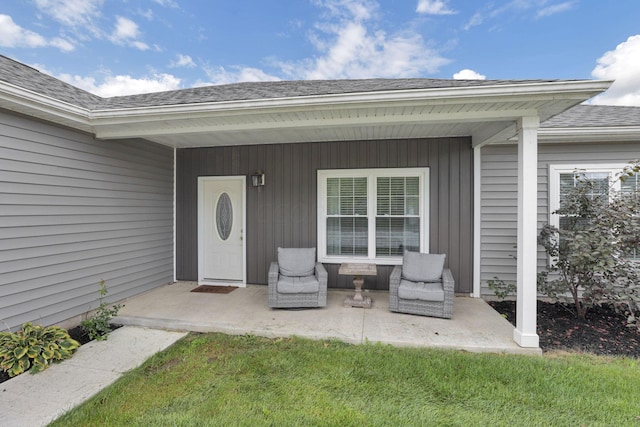 entrance to property with a lawn and a patio