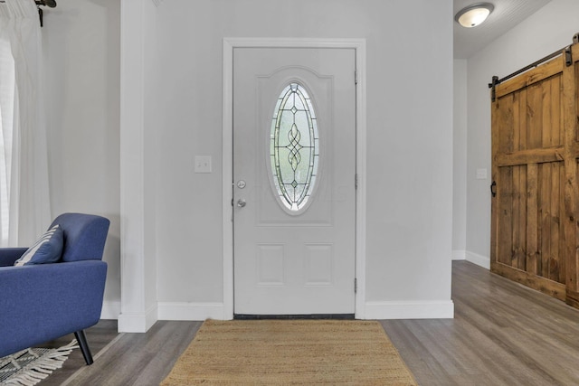 foyer featuring hardwood / wood-style floors and a barn door