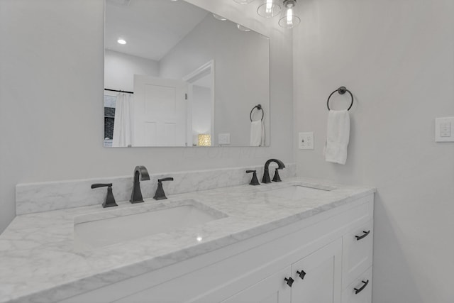 bathroom with curtained shower and vanity