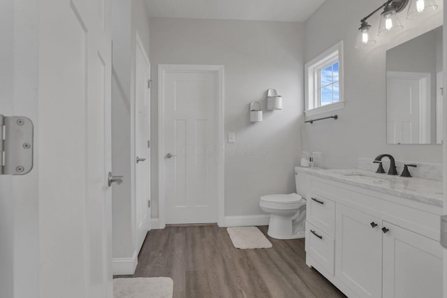 bathroom featuring hardwood / wood-style floors, vanity, and toilet