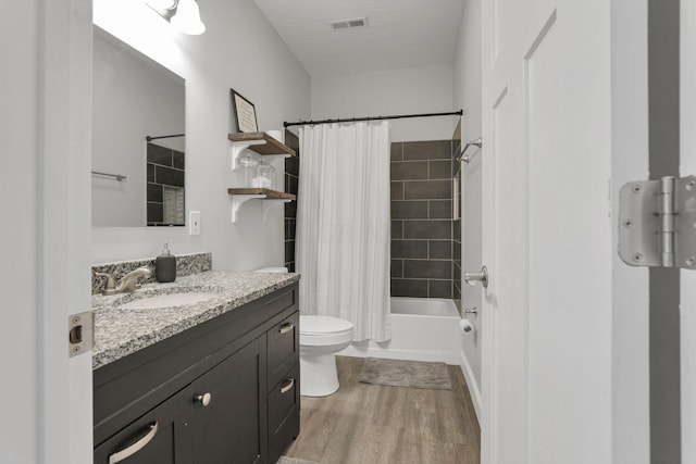 full bathroom featuring shower / bathtub combination with curtain, hardwood / wood-style floors, vanity, and toilet