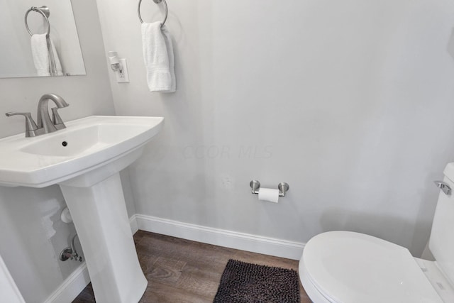 bathroom featuring hardwood / wood-style floors, toilet, and sink