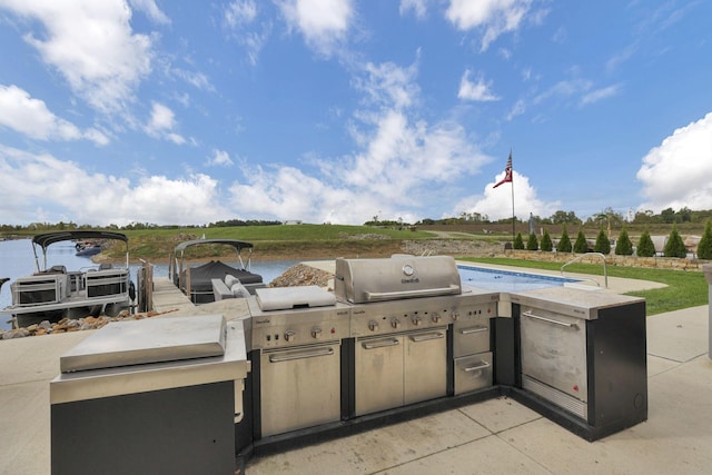 view of patio / terrace featuring a water view and area for grilling