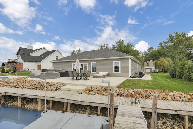 back of property with central air condition unit, an outdoor living space, a yard, and a patio