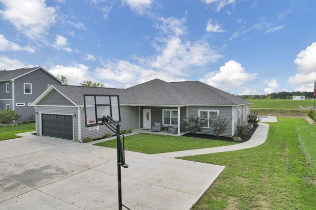 ranch-style house featuring a garage and a front yard